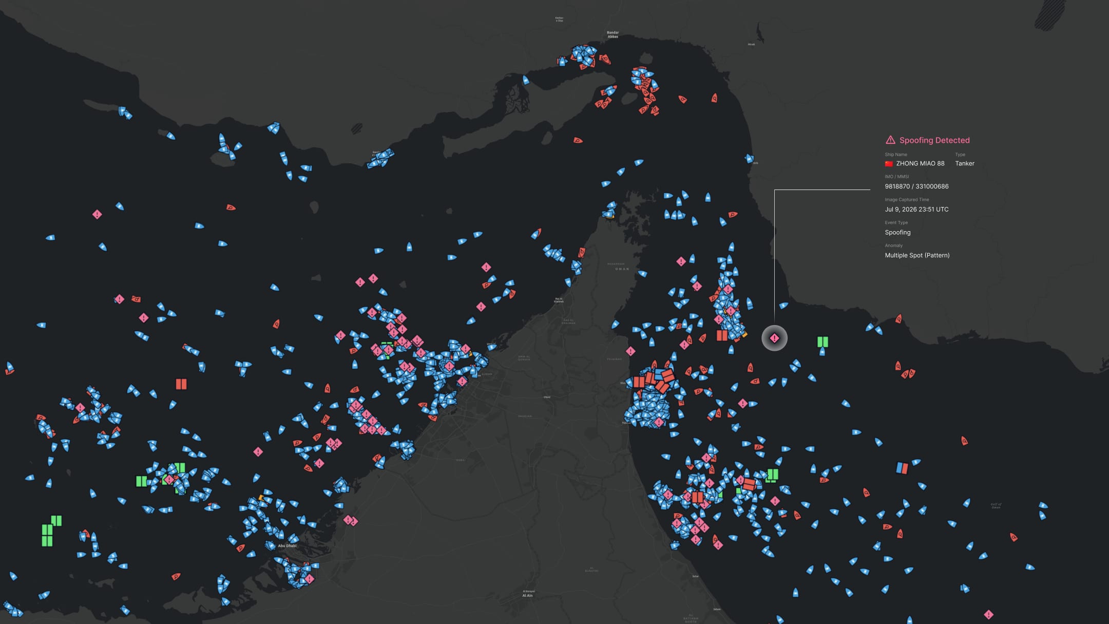 Theia vessel tracking map flagging AIS spoofing, with a tanker broadcasting a falsified position pattern